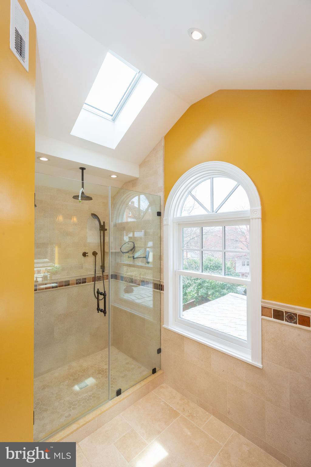 1213 Forest Glen Road Silver Spring, MD 20901 - Photo 43 of 57 a bathroom with a glass shower door and a window