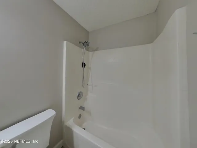 a bathroom with a bathtub and toilet