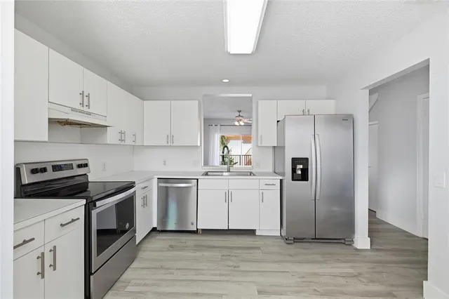 a kitchen with a white cabinets and white appliances