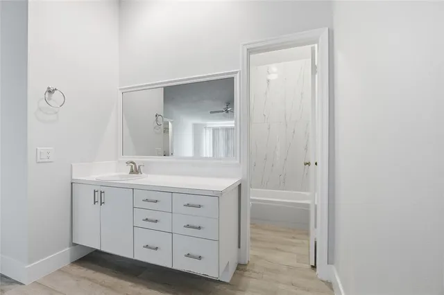 wooden floor in an empty room with a window