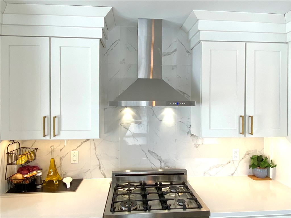 145 Graystone Street Warwick, RI 02886 - Photo 10 of 23 Shown: White shaker cabinets, pure white quartz counters, Tile backsplash. Appliances may differ.