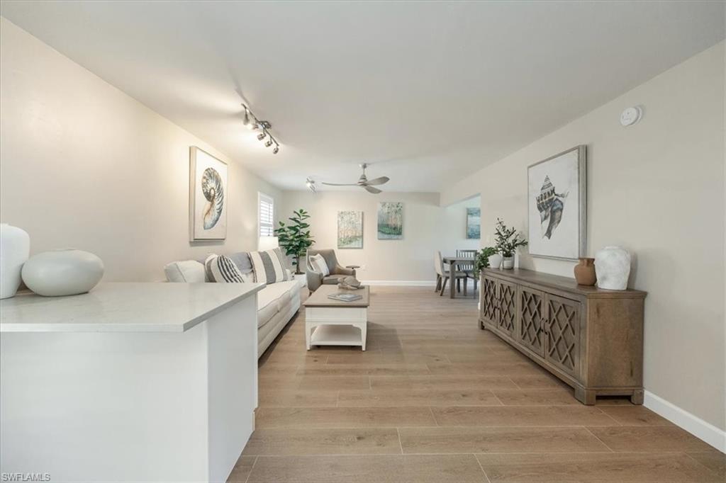 626 12th Avenue South, Unit 626 Naples, FL 34102 - Photo 11 of 50 a living room with furniture and a wooden floor