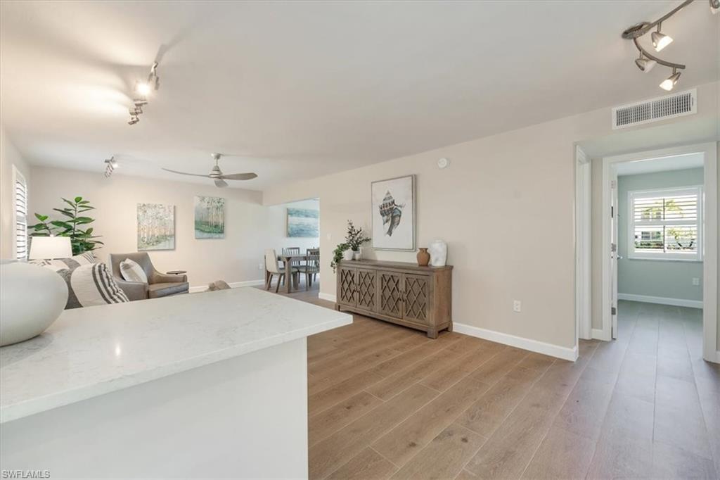 626 12th Avenue South, Unit 626 Naples, FL 34102 - Photo 12 of 50 a living room with furniture and a wooden floor