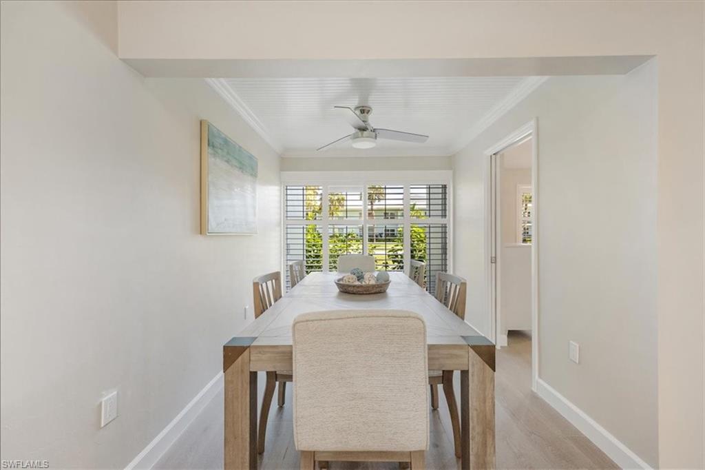 626 12th Avenue South, Unit 626 Naples, FL 34102 - Photo 15 of 50 a view of a dining room with furniture window and outside view