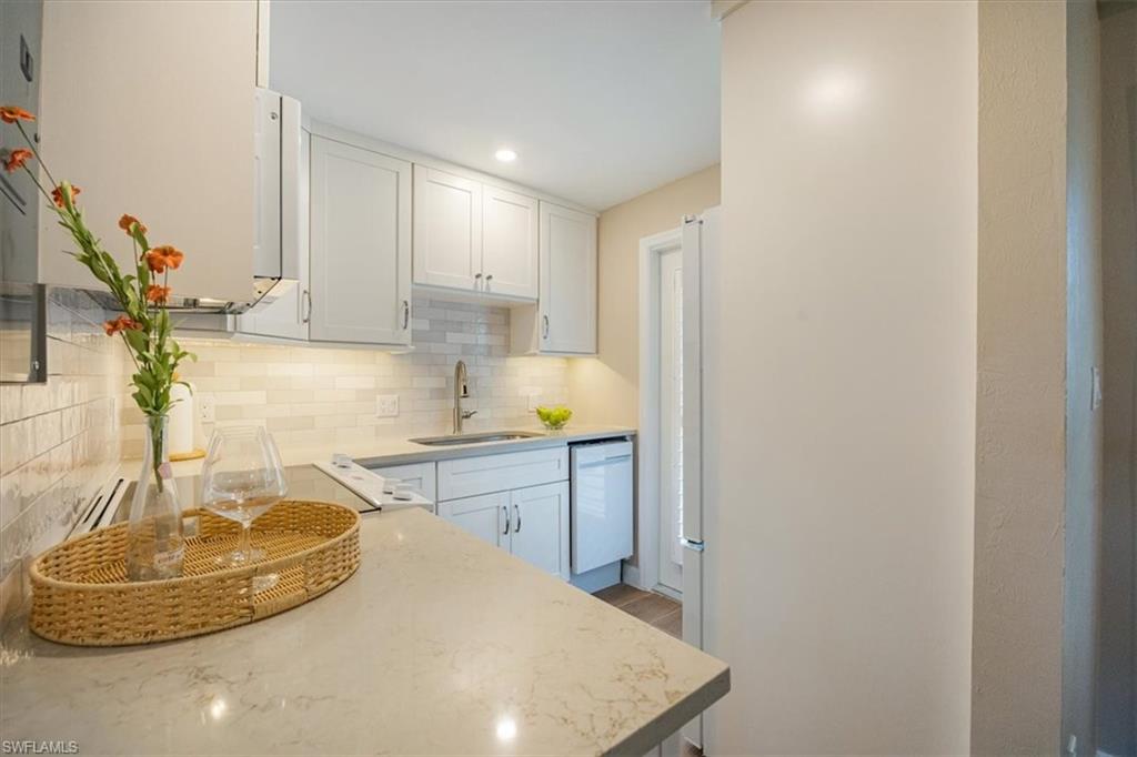 626 12th Avenue South, Unit 626 Naples, FL 34102 - Photo 19 of 50 a kitchen with a sink and a stove top oven