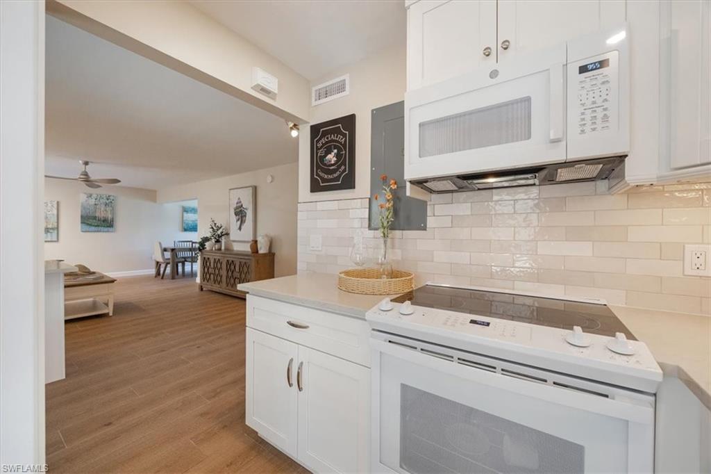 626 12th Avenue South, Unit 626 Naples, FL 34102 - Photo 21 of 50 a bathroom with a sink a large mirror and a shower