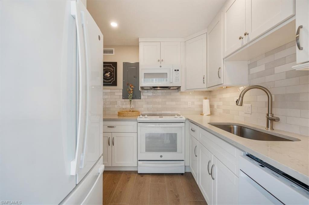 626 12th Avenue South, Unit 626 Naples, FL 34102 - Photo 22 of 50 a kitchen with stainless steel appliances granite countertop a sink and cabinets