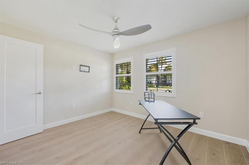 626 12th Avenue South, Unit 626 Naples, FL 34102 - Photo 24 of 50 a living room with a window and a wooden floor