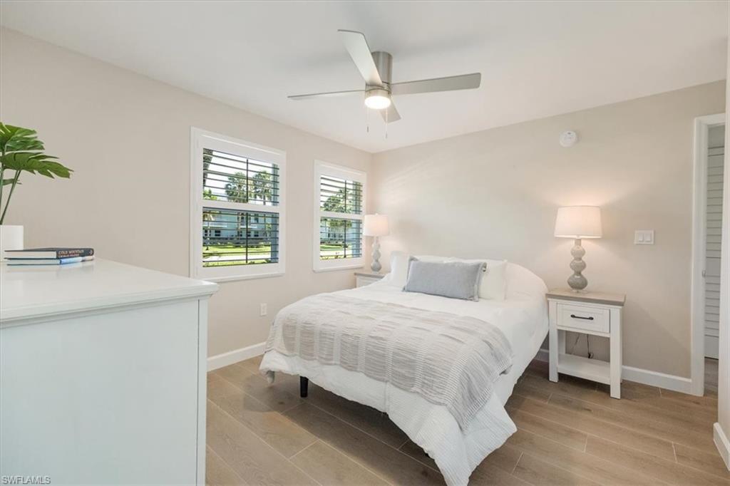 626 12th Avenue South, Unit 626 Naples, FL 34102 - Photo 27 of 50 a bedroom with a bed and a table in it
