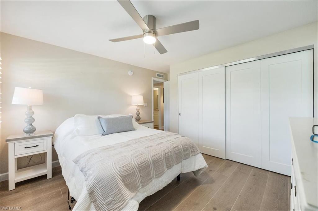 626 12th Avenue South, Unit 626 Naples, FL 34102 - Photo 29 of 50 a bedroom with a bed and a lamp