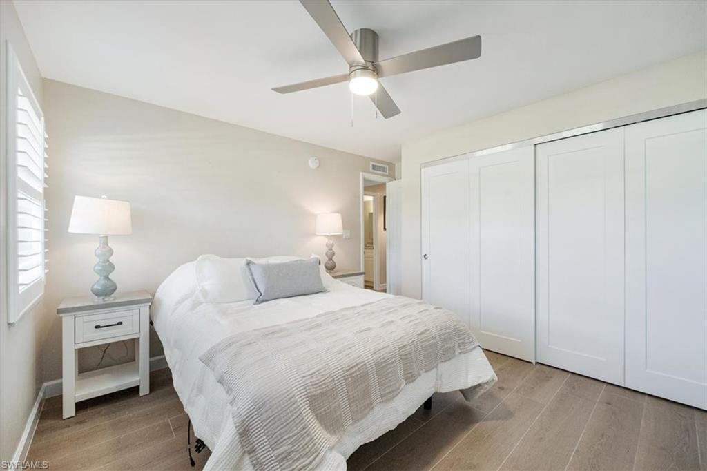 626 12th Avenue South, Unit 626 Naples, FL 34102 - Photo 30 of 50 a bedroom with a bed and a chandelier