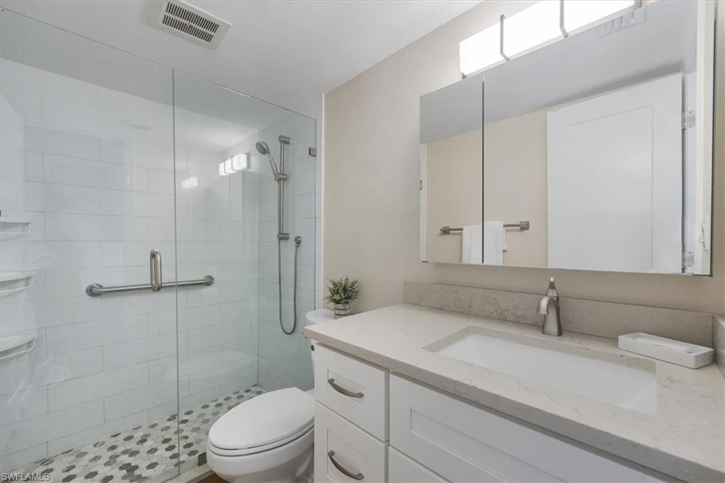 626 12th Avenue South, Unit 626 Naples, FL 34102 - Photo 32 of 50 a bathroom with a sink a toilet and shower