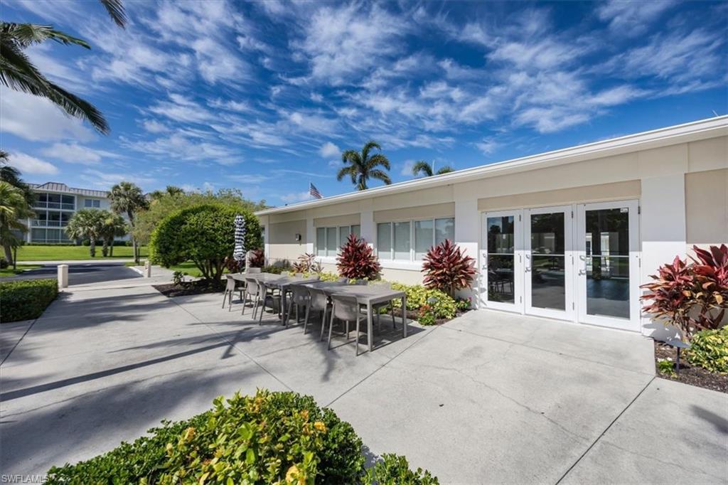 626 12th Avenue South, Unit 626 Naples, FL 34102 - Photo 39 of 50 a view of a patio with table and chairs and potted plants