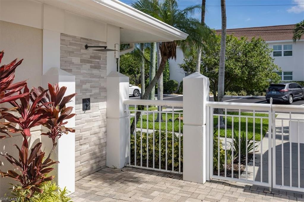 626 12th Avenue South, Unit 626 Naples, FL 34102 - Photo 40 of 50 a front view of a house with a garden