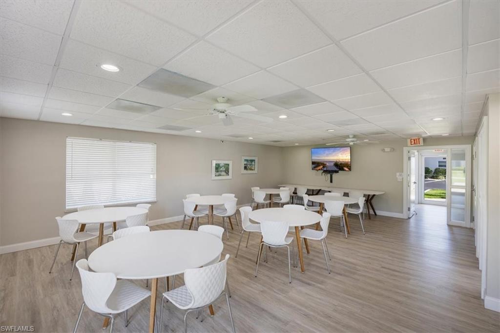 626 12th Avenue South, Unit 626 Naples, FL 34102 - Photo 41 of 50 a view of a dining room with furniture window and wooden floor