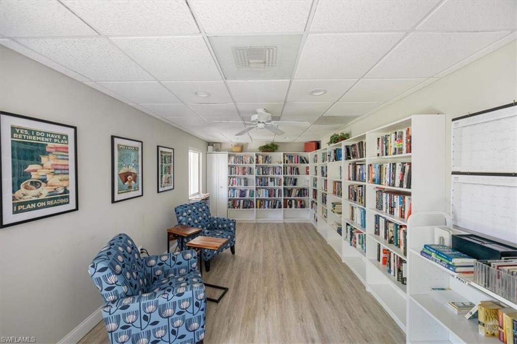 626 12th Avenue South, Unit 626 Naples, FL 34102 - Photo 43 of 50 a living room with furniture and a book shelf