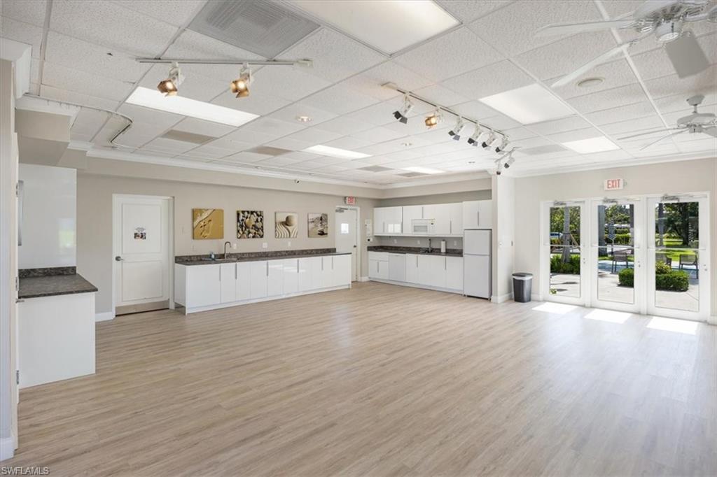 626 12th Avenue South, Unit 626 Naples, FL 34102 - Photo 44 of 50 a view of a big room with wooden floor and windows