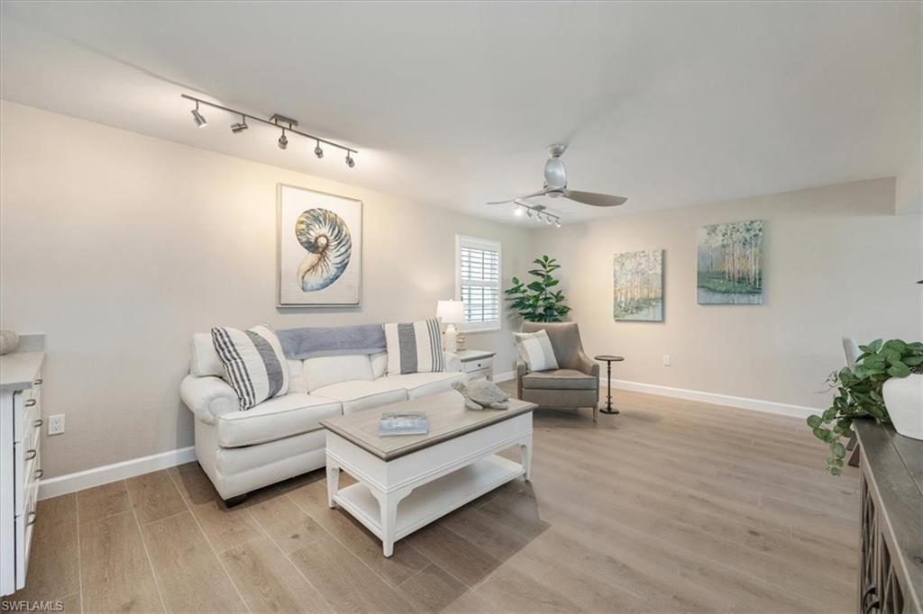 626 12th Avenue South, Unit 626 Naples, FL 34102 - Photo 6 of 50 a living room with furniture and a large window