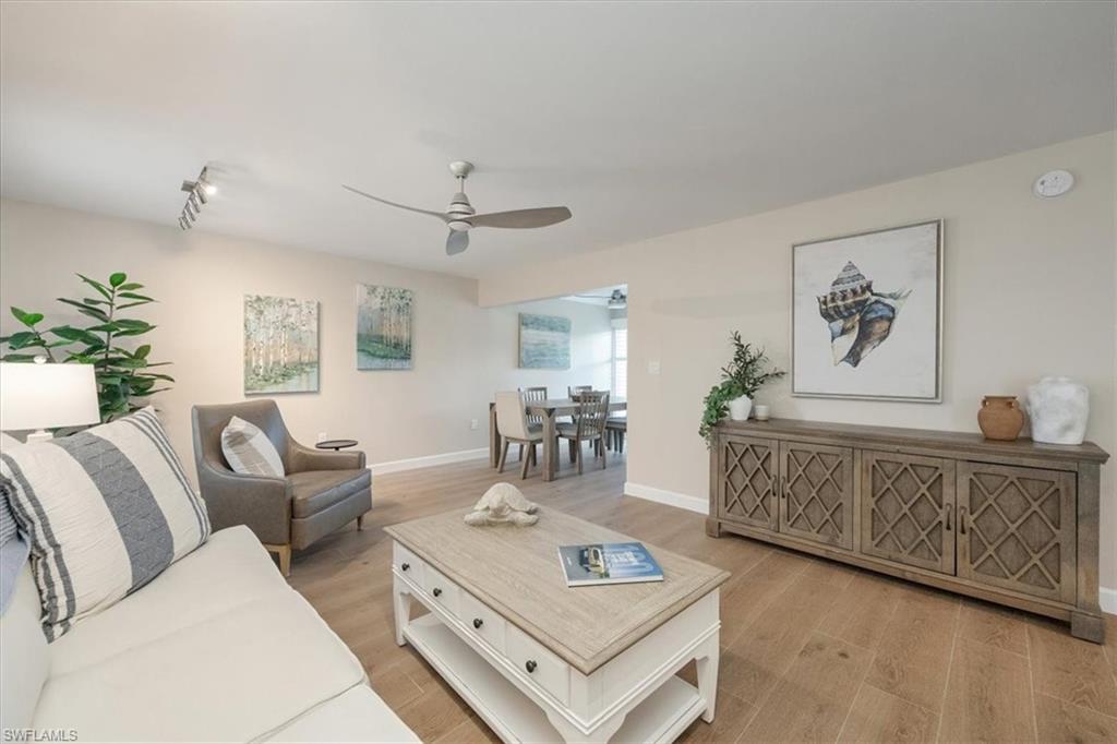 626 12th Avenue South, Unit 626 Naples, FL 34102 - Photo 7 of 50 a living room with furniture and wooden floor