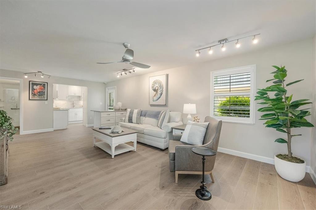 626 12th Avenue South, Unit 626 Naples, FL 34102 - Photo 8 of 50 a living room with furniture and a potted plant
