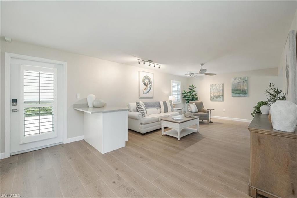 626 12th Avenue South, Unit 626 Naples, FL 34102 - Photo 10 of 50 a living room with furniture and a large window