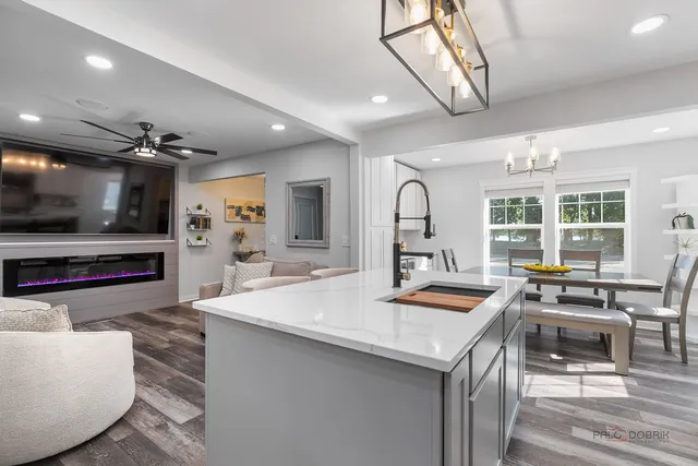 a kitchen with stainless steel appliances granite countertop a sink and a stove