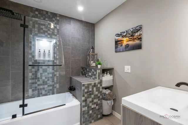 a bathroom with a sink a mirror and a bathtub