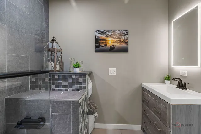 a bathroom with a sink a mirror and vanity