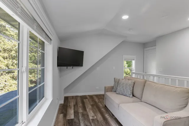 a living room with a flat screen tv and a floor to ceiling window