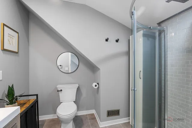 a bathroom with a toilet a sink and shower