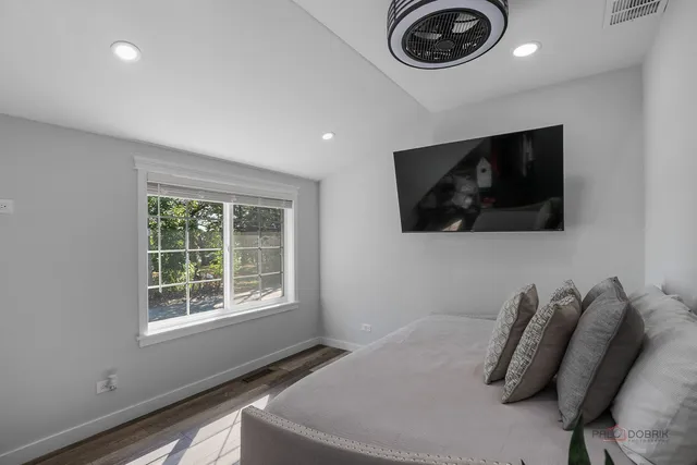 a bedroom with bed and a flat screen tv