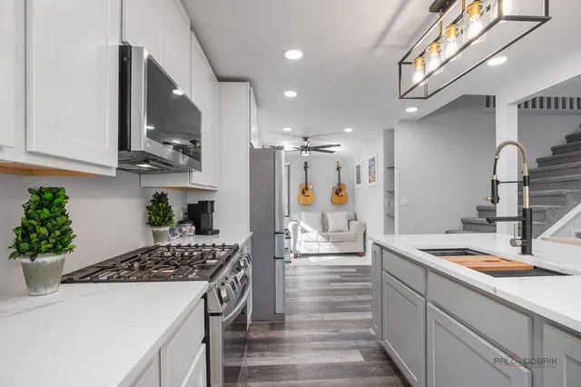 a kitchen with a sink stove and cabinets