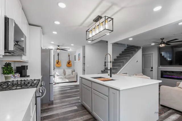 a view of kitchen with sink microwave and stove