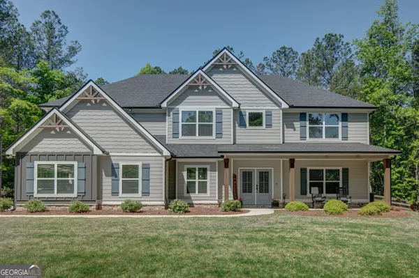 a front view of a house with a yard and porch