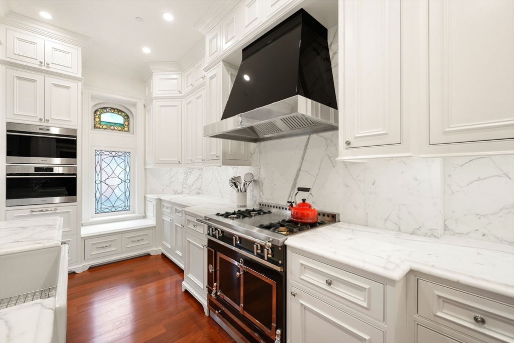 314 Commonwealth Avenue, Unit 2 Boston, MA 02115 - Photo 11 of 31 a kitchen with stainless steel appliances granite countertop a stove a sink and a microwave