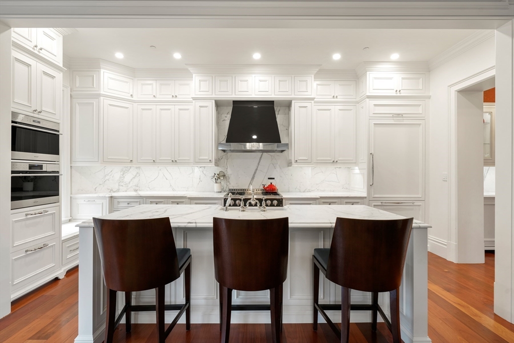 314 Commonwealth Avenue, Unit 2 Boston, MA 02115 - Photo 12 of 31 a kitchen with stainless steel appliances a dining table chairs and sink