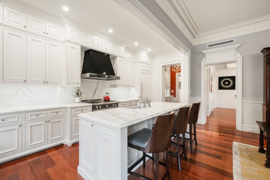 314 Commonwealth Avenue, Unit 2 Boston, MA 02115 - Photo 13 of 31 a kitchen that has a dining table and chairs in it