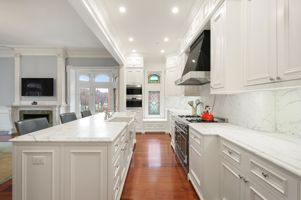 314 Commonwealth Avenue, Unit 2 Boston, MA 02115 - Photo 14 of 31 a kitchen that has a lot of white cabinets and stainless steel appliances