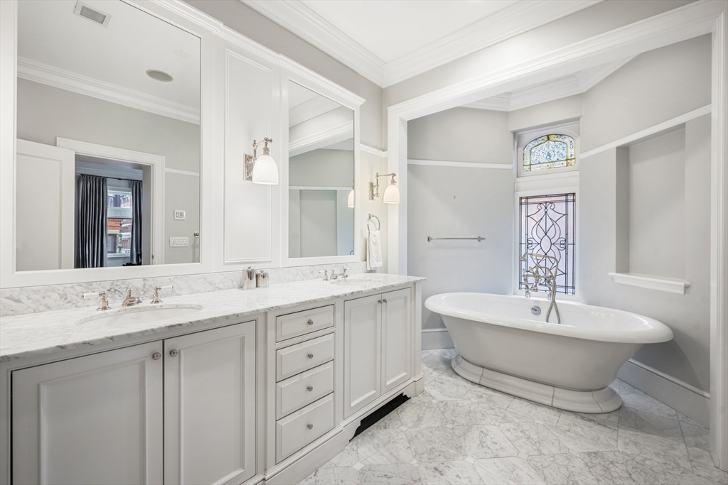 314 Commonwealth Avenue, Unit 2 Boston, MA 02115 - Photo 24 of 31 a spacious bathroom with a double vanity sink mirror and bathtub