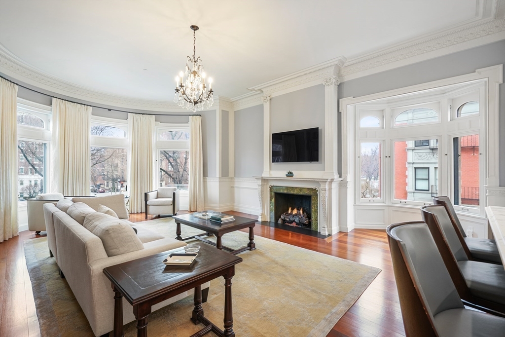 314 Commonwealth Avenue, Unit 2 Boston, MA 02115 - Photo 4 of 31 a living room with furniture a fireplace and a flat screen tv
