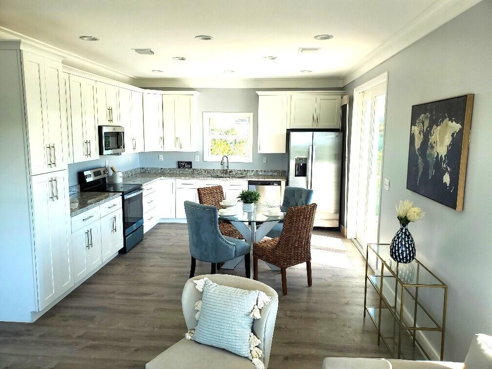 27453 Antigua Road Summerland Key, FL 33042 - Photo 12 of 20 a view of a dining room with furniture and wooden floor