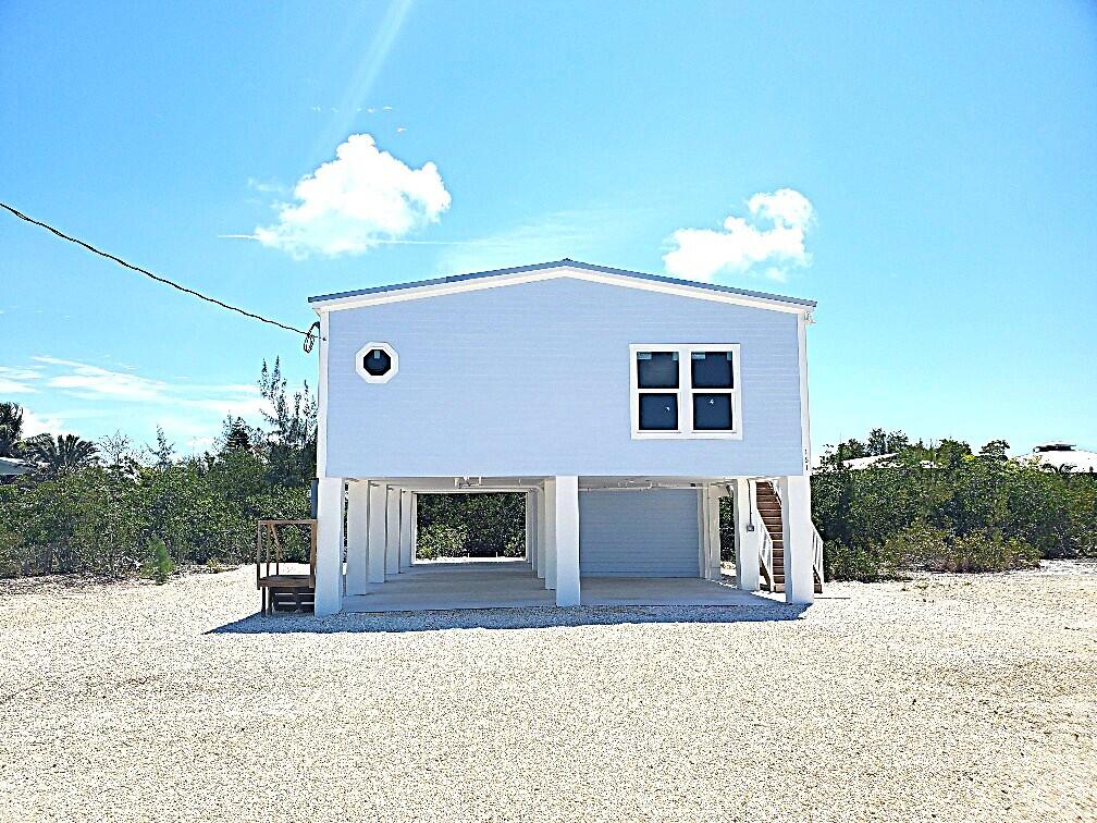 27453 Antigua Road Summerland Key, FL 33042 - Photo 20 of 20 a front view of a house with a yard