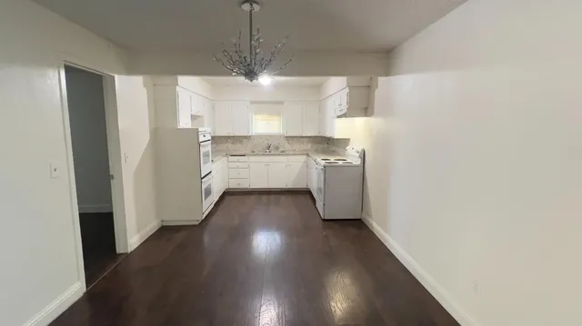 a view of a kitchen with a sink and a stove top oven