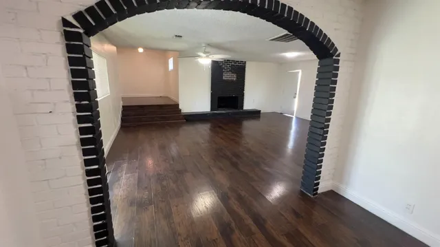 a view of a hallway with wooden floor