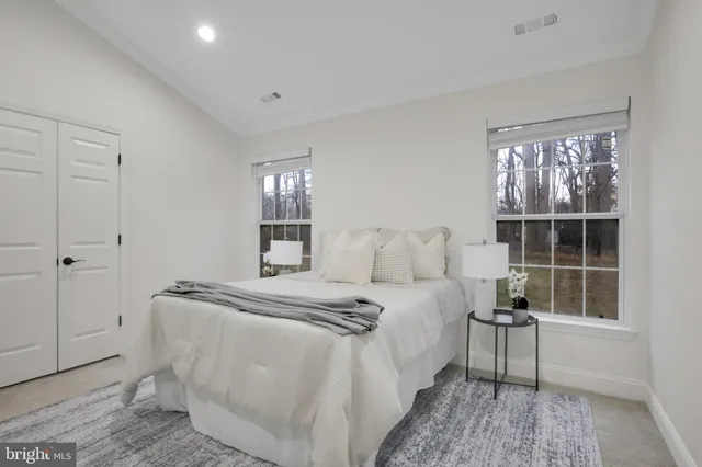 an empty room with a window and a ceiling fan