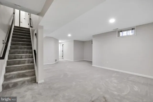 a view of a house with a backyard and wooden deck