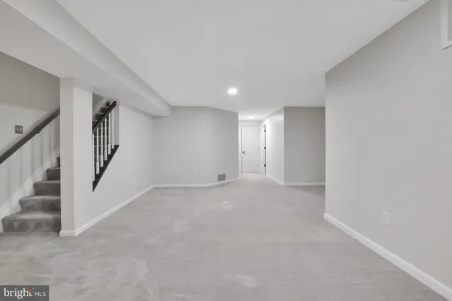 a backyard of a house with wooden roof table and chairs