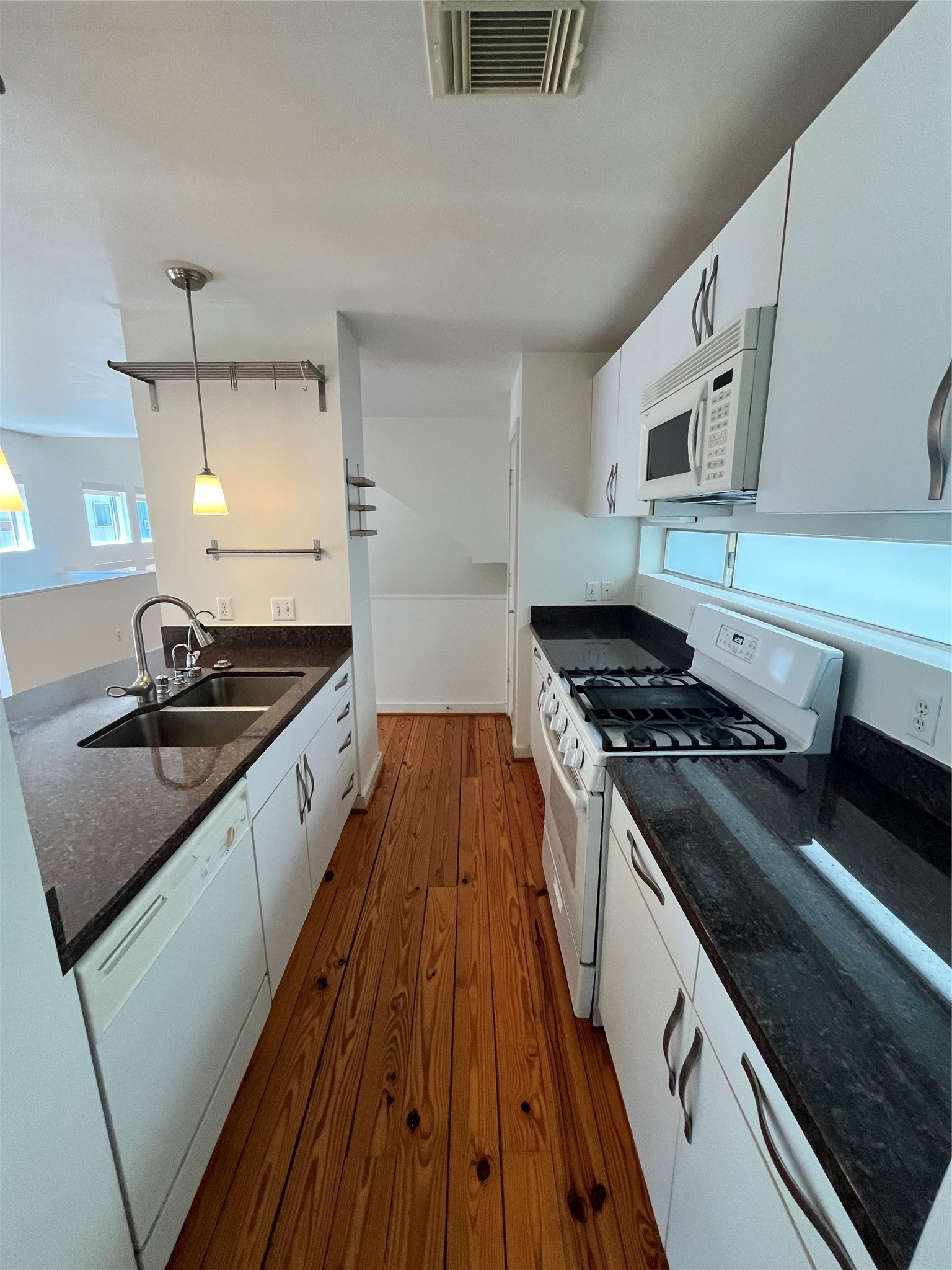 1315 Buckner Street Houston, TX 77019 - Photo 11 of 23 a kitchen with wooden cabinets and a stove top oven