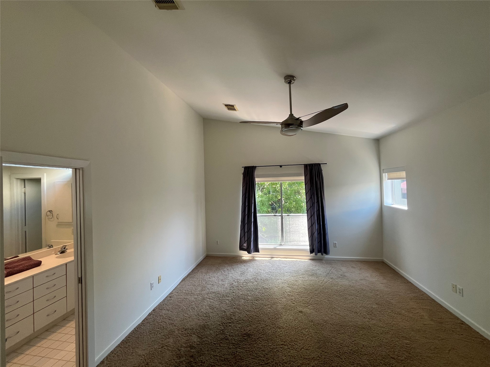 1315 Buckner Street Houston, TX 77019 - Photo 17 of 23 an empty room with a chandelier fan and windows