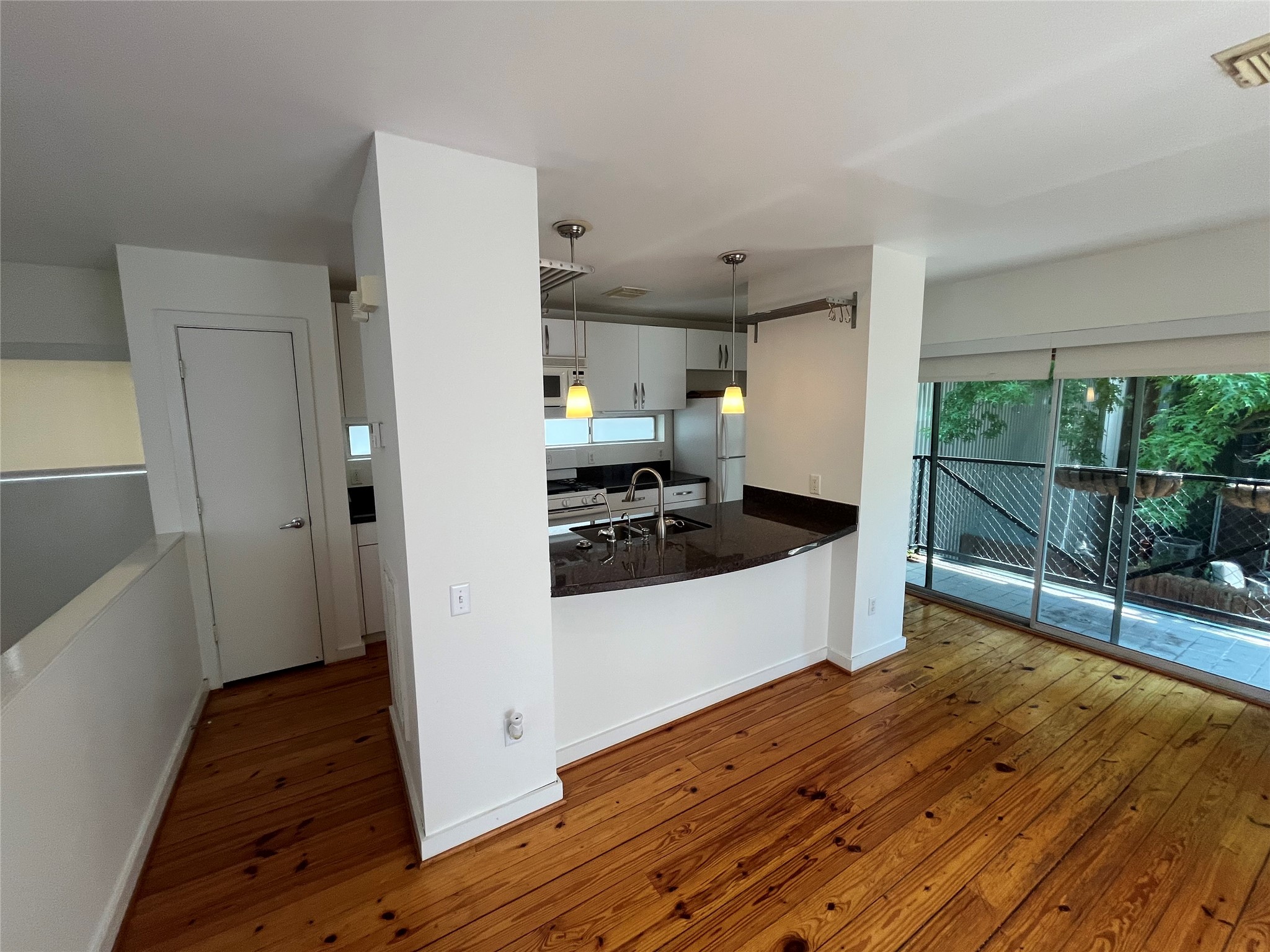 1315 Buckner Street Houston, TX 77019 - Photo 8 of 23 a view of a refrigerator in kitchen and wooden floor